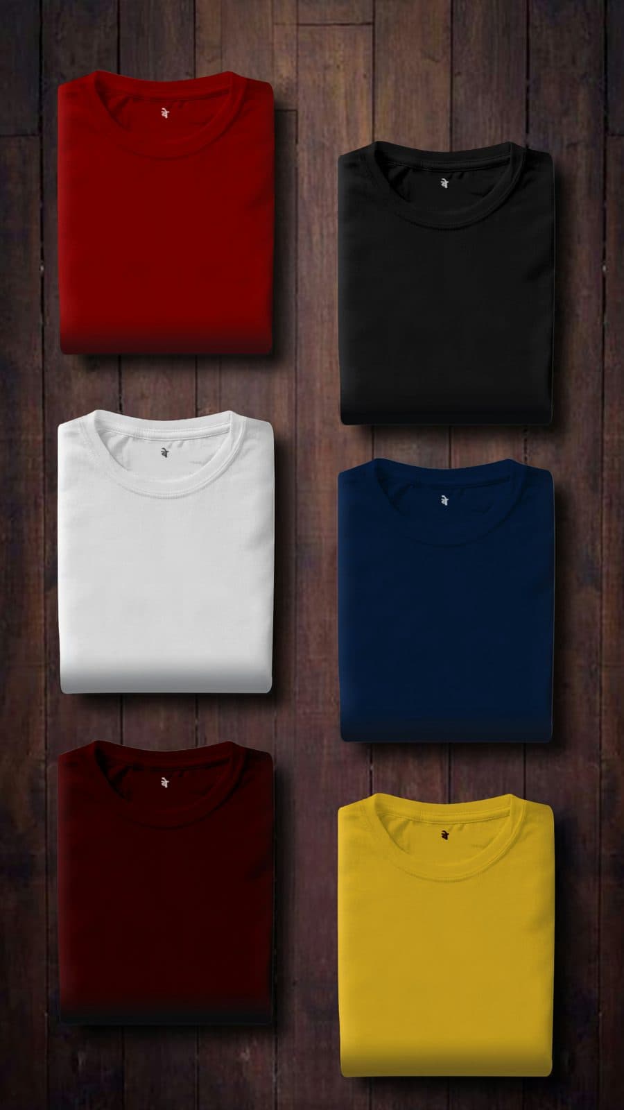 Six folded crew-neck T-shirts in red, black, white, navy, maroon and yellow