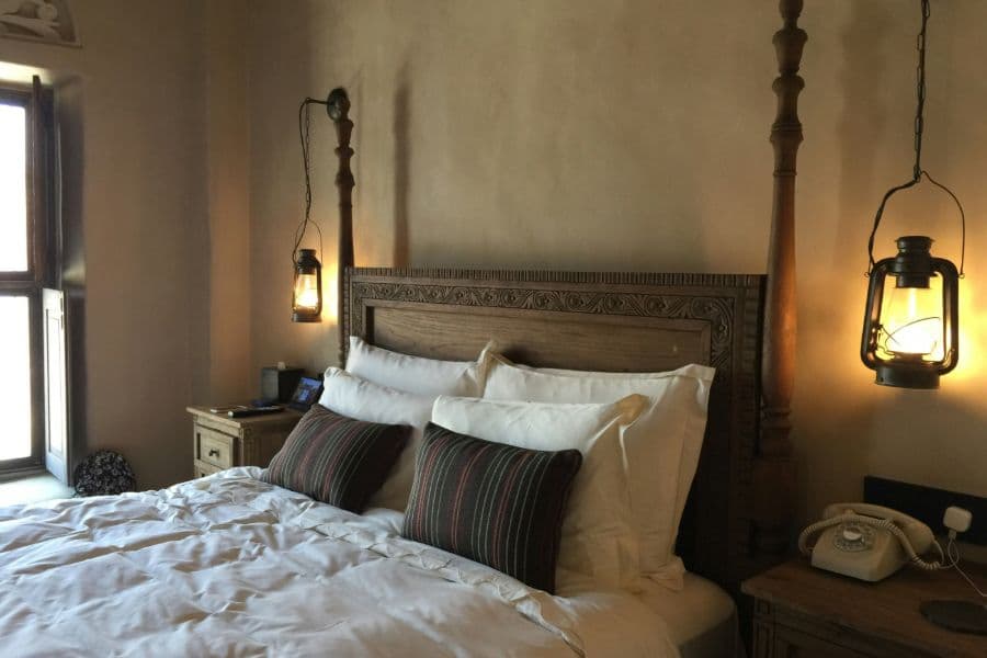 Hotel suite bed dressed in white cotton percale sheets and pillowcases