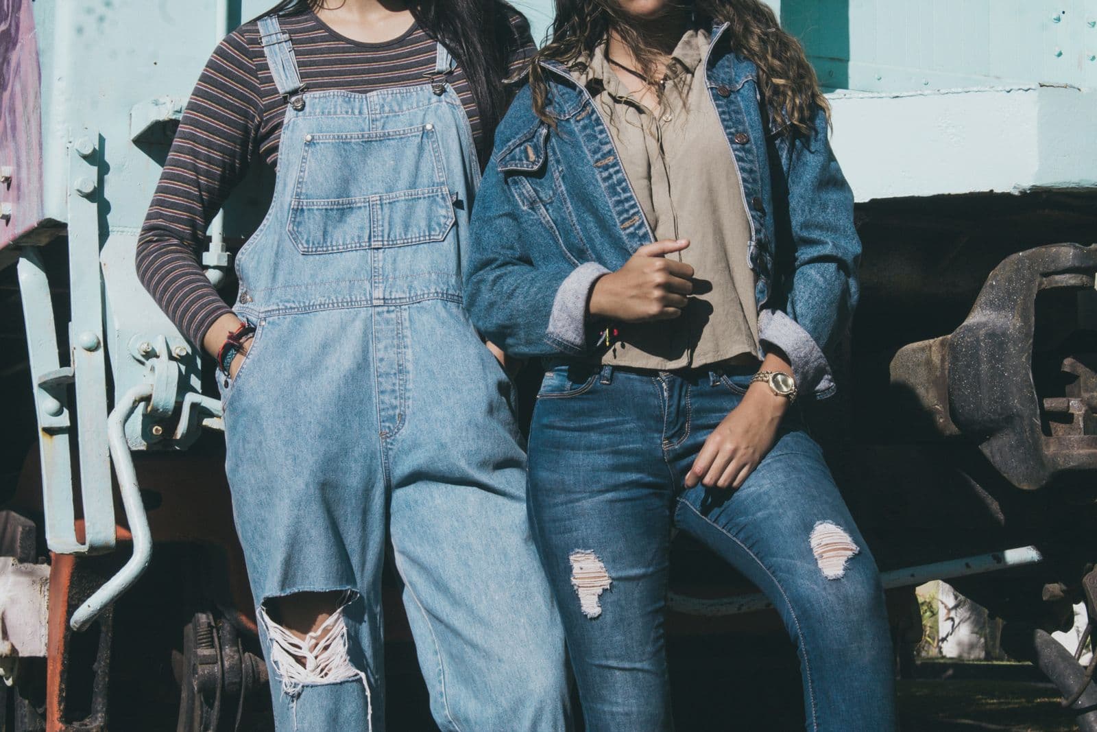 Denim overalls and distressed jeans styled with a denim jacket