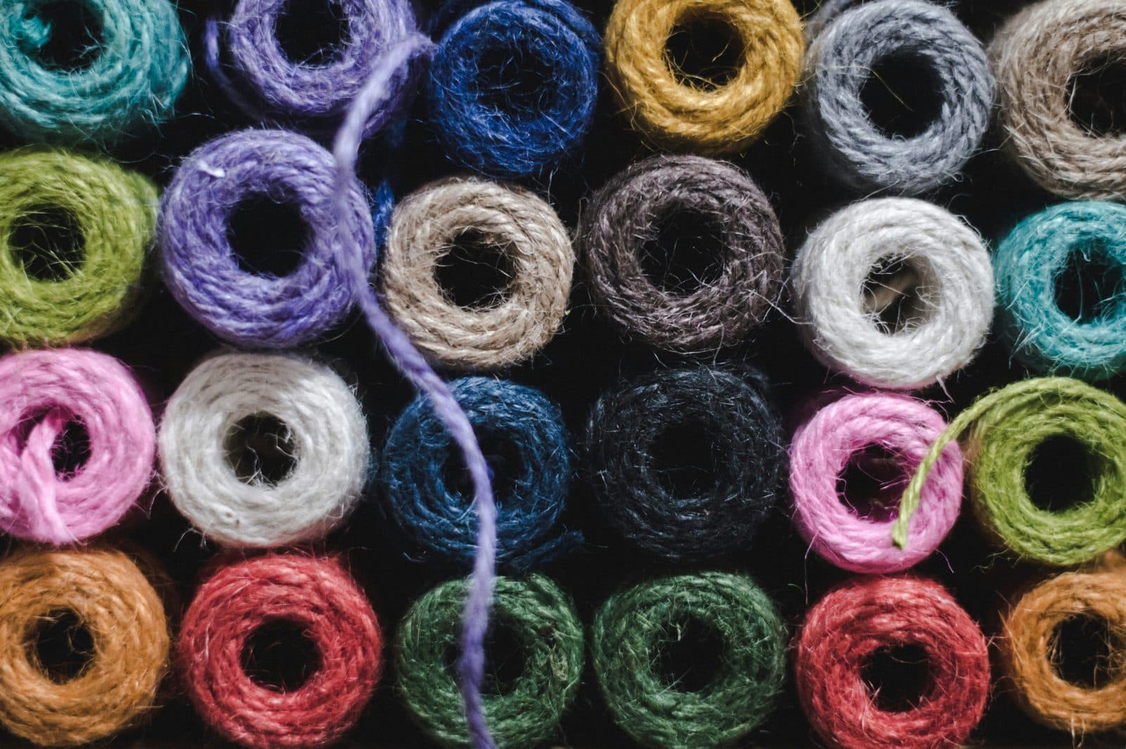 Rolls of coloured jute twine in purple, blue, green, pink and red